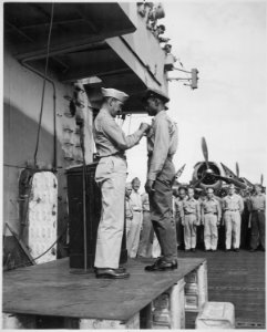 Capt. H. W. Taylor making award presentations aboard U.S.S. Cowpens (CVL 25). Fred Magee, Jr., St3-c USN, receiving com - NARA - 520664