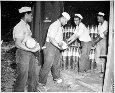 Enlisted men serving on Espiritu Santo in the New Hebrides...placing 6-inch shells in magazines at the Naval Ammunition - NARA - 520631