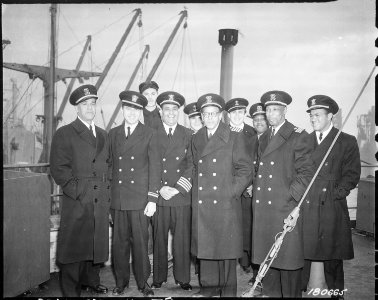 Captain and crew of a new Liberty Ship (SS Booker T. Washington) just after it completed its maiden voyage to England. - NARA - 531168 photo