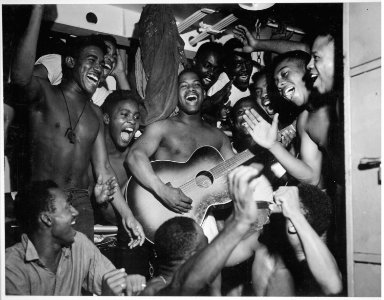 Enlisted men aboard the U.S.S. Ticonderoga (CV-14) hear the news of Japan's surrender., 08-14-1945 - NARA - 520868