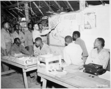 Negro members of the 477th Antiaircraft Artillery, Air Warning Battalion, study maps in the operations section at Oro B - NARA - 531348