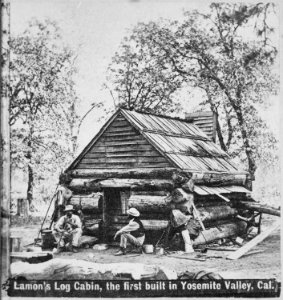 Lamon's log cabin, the first built in Yosemite Valley, Calif. Their work completed, two men sit on stumps in front of - NARA - 559326 photo