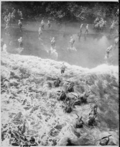 Marines hit three feet of rough water as they leave their LST to take the beach at Cape Gloucester, New Britain., 12-2 - NARA - 532361