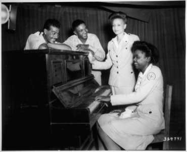 Negro GIs and American Red Cross workers, college graduates, join in some musical fun at Assam, India..., 08-23-1944 - NARA - 531351