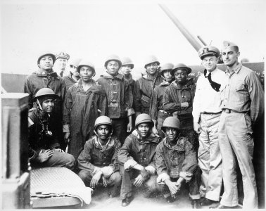 Negro messmen aboard a United States Navy cruiser who volunteered for additional duty as gunners. They have been doing - NARA - 520597