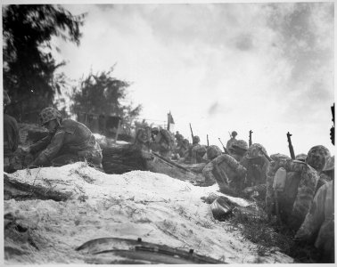 Negro assault troops await orders D-day to attack enemy shortly after they had come ashore at Saipan in the Marianas., - NARA - 532528