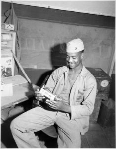 Pfc. Luther Woodward..., a member of the Fourth Ammunition Company, admires the Bronze Star awarded to him for `his bra - NARA - 532553
