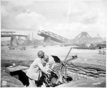 Pvts. George Cofield...and Howard J. Davis...guard a newly-constructed bridge site over the Rhine River, built by U.S. - NARA - 531273