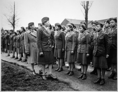 Somewhere in England, Maj. Charity E. Adams...and Capt. Abbie N. Campbell...inspect the first contingent of Negro mem - NARA - 531249