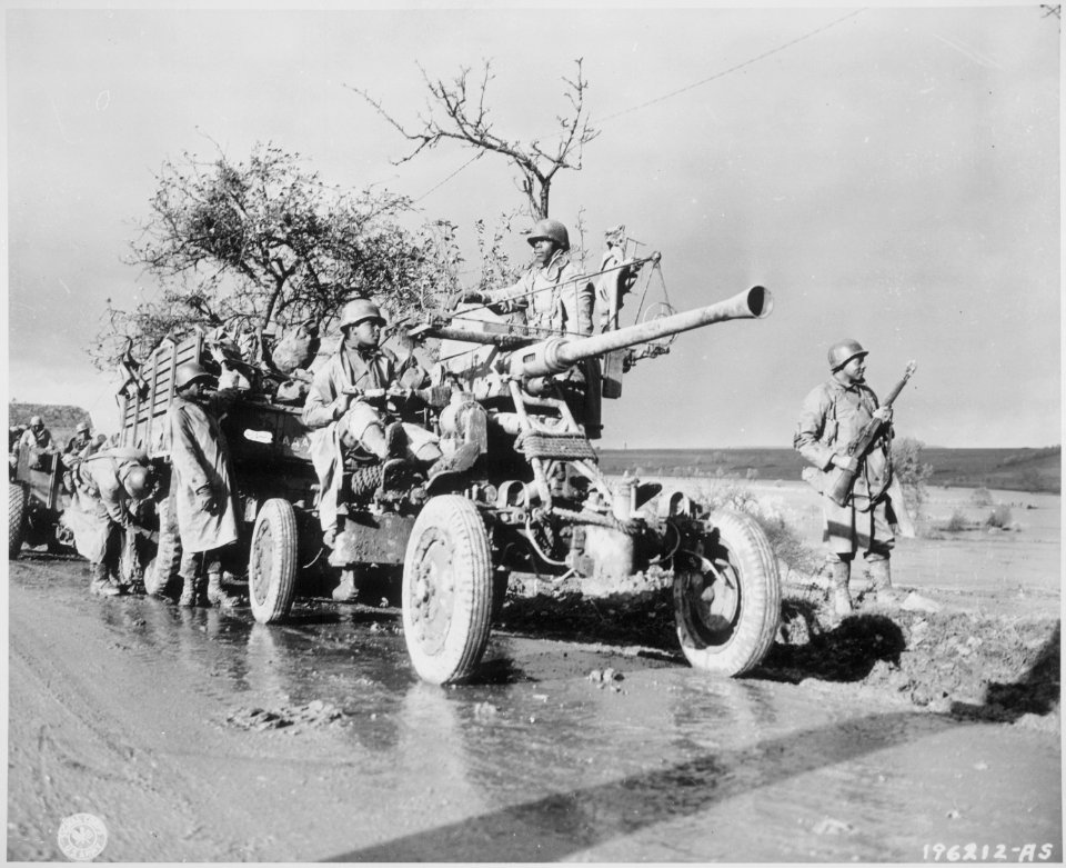 Members of Battery A, 4520 AA stand by and check their equipment while the convoy takes a break., 11-09-1944 - NARA - 531222