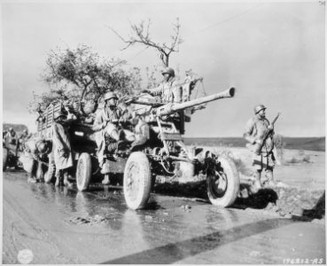 Members of Battery A, 4520 AA stand by and check their equipment while the convoy takes a break., 11-09-1944 - NARA - 531222