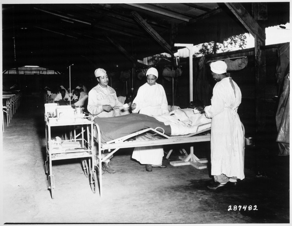 Surgical ward treatment at the 268th Station Hospital, Base A, Milne Bay, New Guinea. Left to right, Sgt. Lawrence McKr - NARA - 530771