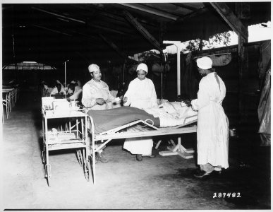 Surgical ward treatment at the 268th Station Hospital, Base A, Milne Bay, New Guinea. Left to right, Sgt. Lawrence McKr - NARA - 530771 photo