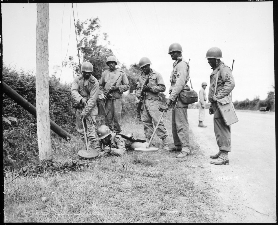 This mine detector crew is demonstrating what they do before going to work on or around telephone poles in France., 07 - NARA - 531193
