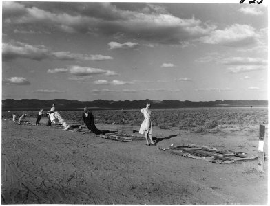 (Operation Cue) - Line of manikins at 7,000 feet, part of thermal radiation test (, after blast) - NARA - 541789