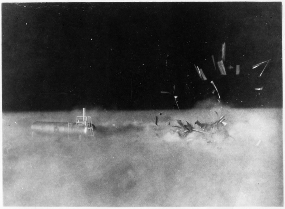 (Operation Cue) - One-story shed beside LP (liquified petroleum) tank as blast wave hits disintegrating shed - NARA - 541791