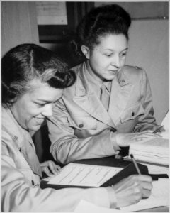 WAACs at work in Temp. Bldg. `M', 26th Street, Washington, DC, WAAC Headquarters. Left to right, Lts. Harriet West and - NARA - 531139 photo