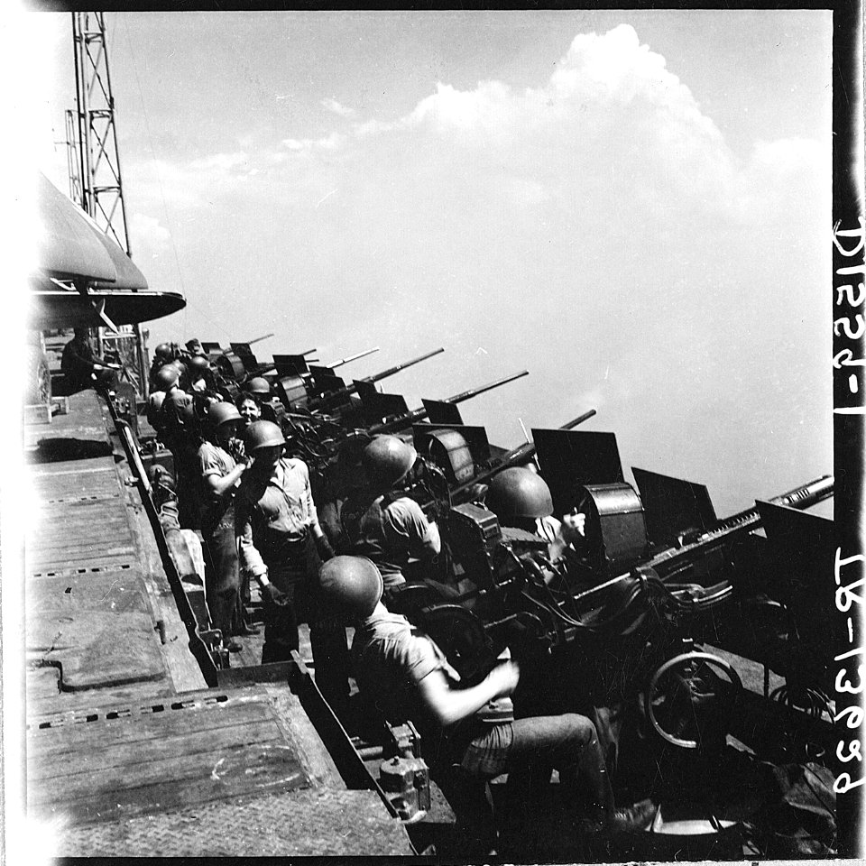 20mm gun crews standing by aboard the USS Hornet (CV-12) as her planes hit Tokyo, Japan. - NARA - 520863