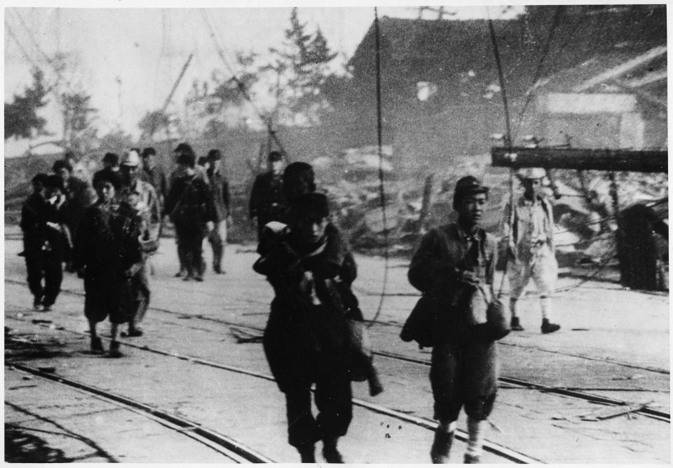 (Survivors moving along the road after the atomic bombing of Nagasaki, Japan.) - NARA - 558581