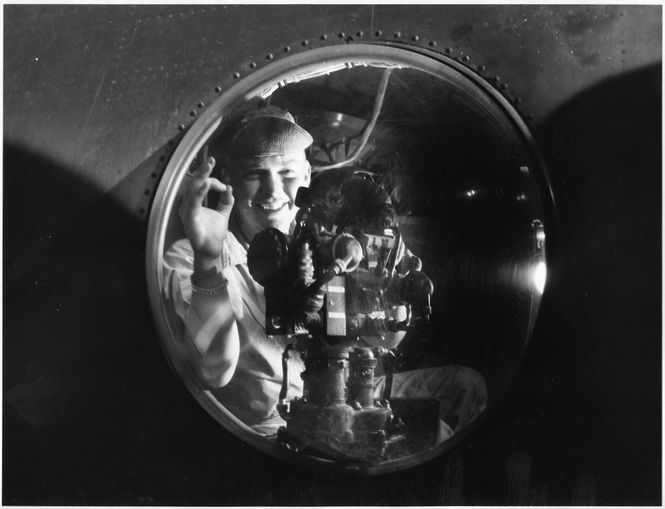 20TH AIR FORCE, OKINAWA-A-2C Don W. Murray of Mazon, Ill., flashes a victory smile from the gun blister of his U.S.... - NARA - 542361