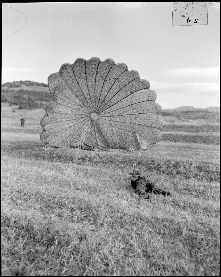 A Republic of Korea paratrooper deflates his parachute following a three point landing during a mass paradrop... - NARA - 542278