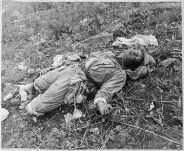 A Chinese soldier, killed by Marines of the 1st Marine Division in Korea during attack on Hill 1051, on Kari San... - NARA - 520794 photo