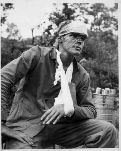A wounded U.S. Marine awaiting transportation back to a field hospital after receiving first-aid at the battle zone.... - NARA - 541964