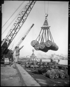 A view of the United Nations fuel dump at Inchon Harbor, Korea. Hundreds of fuel drums are lifted and moved with... - NARA - 530638