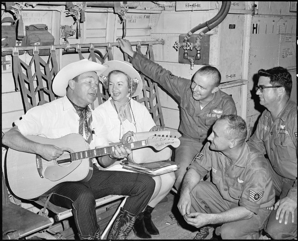 Air Borne Sing-A-Long. Roy and Dale Rogers entertain crew members of an Air Force C-123 Provider during the last leg... - NARA - 542298