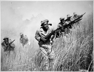 A squad of non-coms, cadres of the 92nd Division, get a refresher course in charging through smoke. When the main body - NARA - 531141