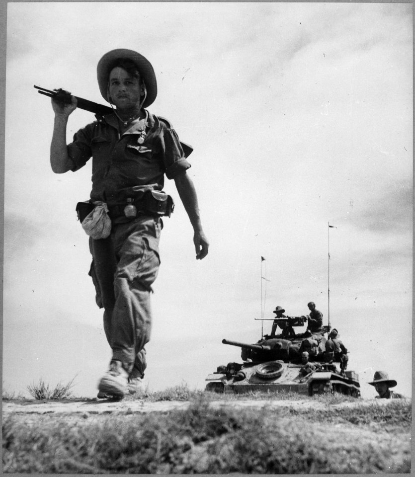 A French Foreign Legionnaire goes to war along the dry rib of a rice paddy, during a recent sweep through communist-held - NARA - 541967