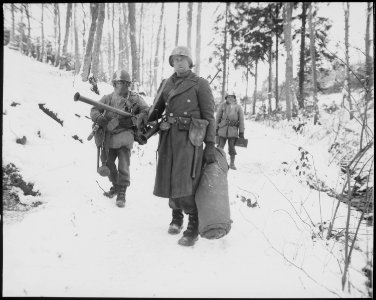 After holding a woodland position all night near Wiltz, Luxembourg, against German counter attack, three men of B... - NARA - 531349