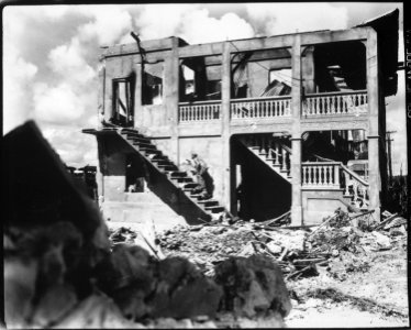 A Marine from the Third Marine Division goes after a sniper in a shelled building. Guam, August 1944. - NARA - 532568 photo