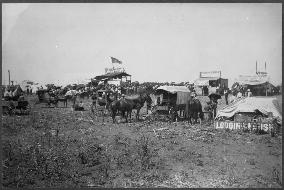 Anadarko Townsite, August 8, 1901. Auction in progress in lumber company booth. Temporary bank buildings and the beginni - NARA - 516444