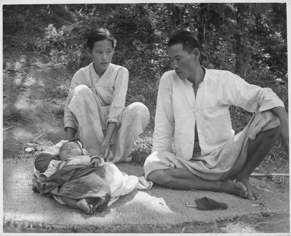 A refugee family from Ching Pung Men near Masan, now living in a refugee camp at Changseung-po, Korea. United Nations. - NARA - 541963