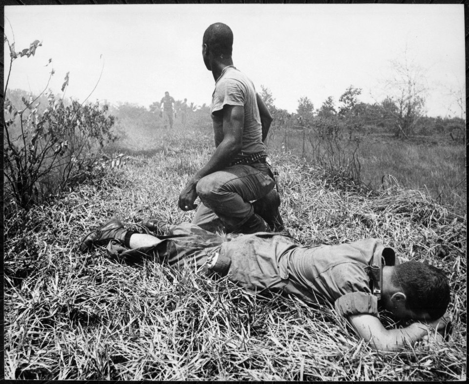 A young American lieutenant, his leg burned by an exploding Viet Cong white phosphorus booby trap, is treated by a medic - NARA - 541863
