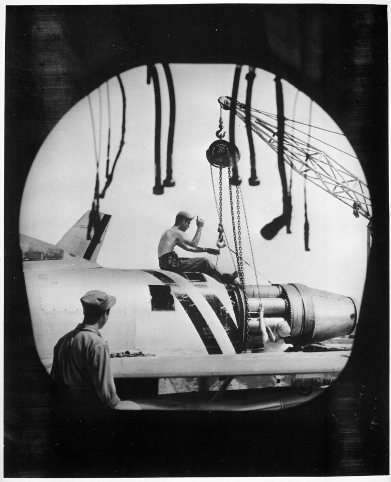 An aircraft maintenance crew of the U.S. Air Forces 4th Fighter-Interceptor Wing in Korea, photographed through the... - NARA - 541961