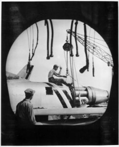 An aircraft maintenance crew of the U.S. Air Forces 4th Fighter-Interceptor Wing in Korea, photographed through the... - NARA - 541961