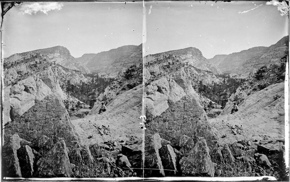Aquarius Plateau. Winslow Creek, branch of the Escalante River. A man is seated on the ground near - NARA - 517987