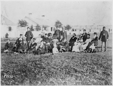 An afternoon of croquet. Ladies, gentlemen, and children on the lawn at Fort Bridger, Wyo. Terr., ca. 1873. Officers' qu - NARA - 530927