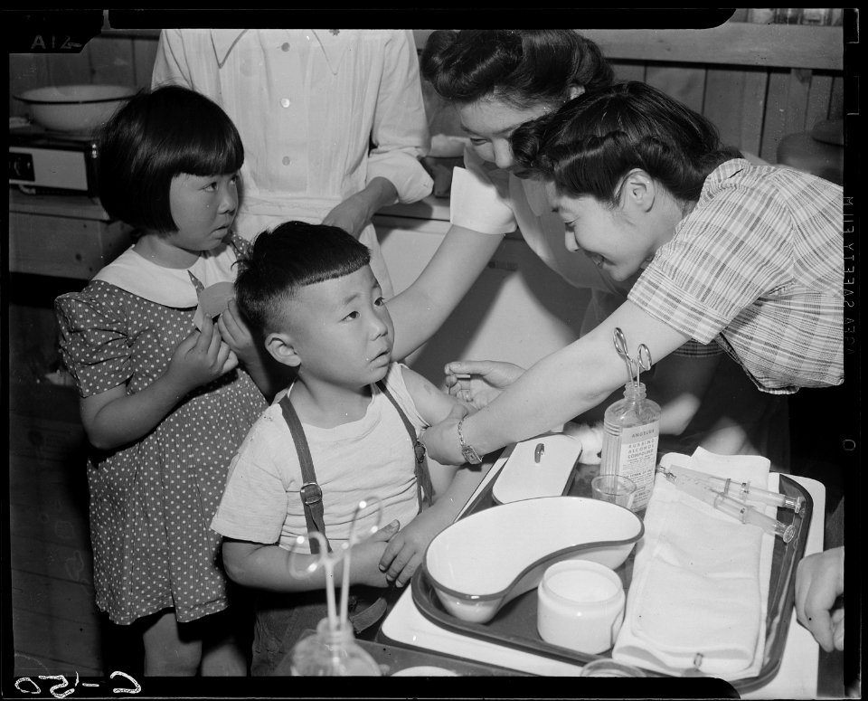 Arcadia, California. Evacuees of Japanese ancestry are vaccinated by fellow evacuees. - NARA - 537424