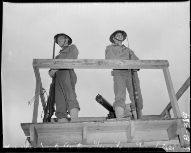 Arcadia, California. Military police on duty in watch-tower at the Santa Anita assembly center for . . . - NARA - 537020