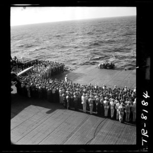 All hands attend burial rites for two crewmen aboard USS Lexington, CV-16. - NARA - 520924 photo