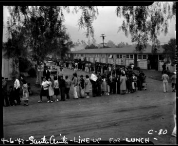 Arcadia, Califonria. Evacuees of Japanese ancestry line up for lunch at the Santa Anita Assembly center. - NARA - 537452