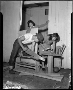 Arcadia, California. Mrs. Lily Okura, with necktie rack, carpet and shelves, begins housekeeping at . . . - NARA - 537057
