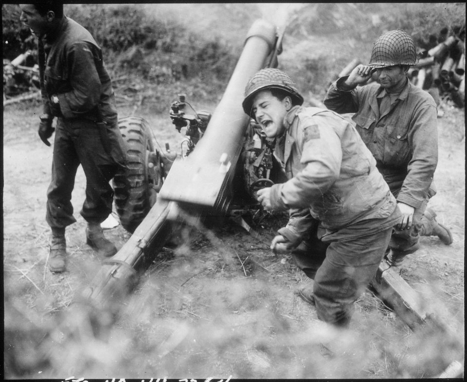 American howitzers shell German forces retreating near Carentan, France. - NARA - 531199