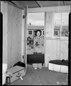 Arcadia, California. Entering her new temporary apartment at the Santa Anita Assembly center to awa . . . - NARA - 537390