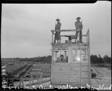 Arcadia, California. Military police on duty in watch-tower at Santa Anita park assembly center for . . . - NARA - 537019