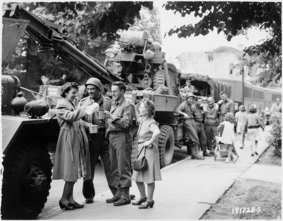 Army Ordnance men await the go signal for cross channel trip to France. British civilians serve hot coffee as the... - NARA - 531195