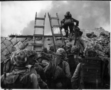 As against The Shores of Tripoli in the Marine Hymn, Leathernecks use scaling ladders to storm ashore at Inchon in... - NARA - 532404